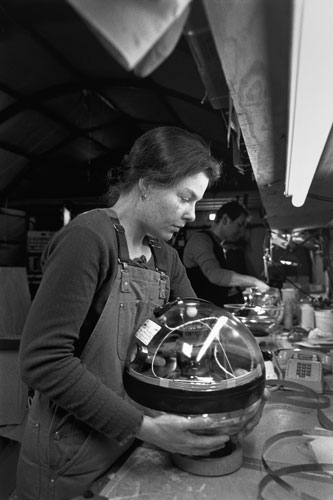 <p>Eva Dahlberg of Sweden seals up an AMANDA Project photo multiplier. Strings of these multipliers will be sunk over a mile into the ice to detect neutrinos passing through the earth.</p><p>"I was finishing a physics degree at Leeds. One of my professors said, &rsquo;Why don&rsquo;t you work for me: We&rsquo;re involved in cosmic rays at a sheep farm at Leeds or at the South Pole. Every Friday at the pub I said, &rsquo;Let me go to the South Pole; I&rsquo;ve got to go to the South Pole.&rsquo; Ever since I came down for the summer I said, &rsquo;I want to winter?&rsquo; So then he said that I could winter so long as I finish my Ph.D. first. So I finished my Ph.D. and a few weeks later I was flying down to winter over."<br/>—Dr. Simon Hart, U.K.</p>