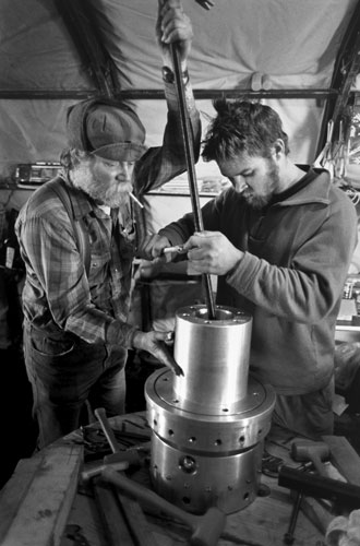 <p>Ice core drillers, Dave Giles and lan Dolman repair a drill motor at Siple Dome on the western ice sheet.</p><p>"The thickness of the ice here, according to radar, is 980 meters. They get the oldest ice. The longest record here is over 30,000 years. The snowfall here is greater than inland, more ice per layer, which gives better resolution for the time period." Dave Giles (left)</p><p>"The ice cores also show ash layers from volcanoes. Major eruptions caused climate changes so an ice core can show the cause and effects of global conditions."<br/>—Dr. Philip Kyle</p>
