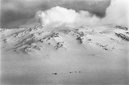 "I climbed up a slope to get a photo of the acclimatization camp. Everywhere I went, I was accompanied by a safety specialist. We had to go the second part of the way up by snow machine on a very steep slope, a dangerously tricky drive. After a bit, my minder asked me to take over because I was more experienced driving snow machines."<br/>—James Barker