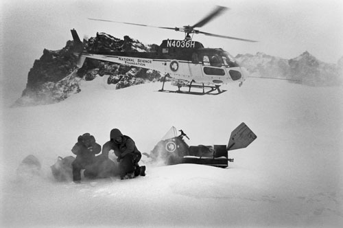 <p>Volcanologists Adam Maciajewski and Kurt Panter land at the Fang Glacier acclimatization camp at 9,400 feet on Mt. Erebus, A three-day stay is required before ascending to the hut at 11,400 feet and the summit.</p><p>"We are driven here by science. Our scientific questions have changed. Now there&rsquo;s less interest in volcanoes per se and, at least in my mind, more interest in the impact of the volcano on the Antarctic environment. We are looking at the air samples at the South Pole to see if we can find signatures of Erebus gas there. This is my 25 field season, my 24th on Erebus. I just wish there was some young upstart that would push me aside and take the place over. But you get a little bit of territory and it&rsquo;s &rsquo;my little bit of territory.&rsquo;"<br/>—Dr. Philip Kyle</p>